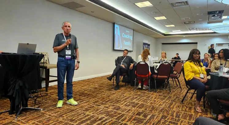 Man speaking at conference in meeting room.