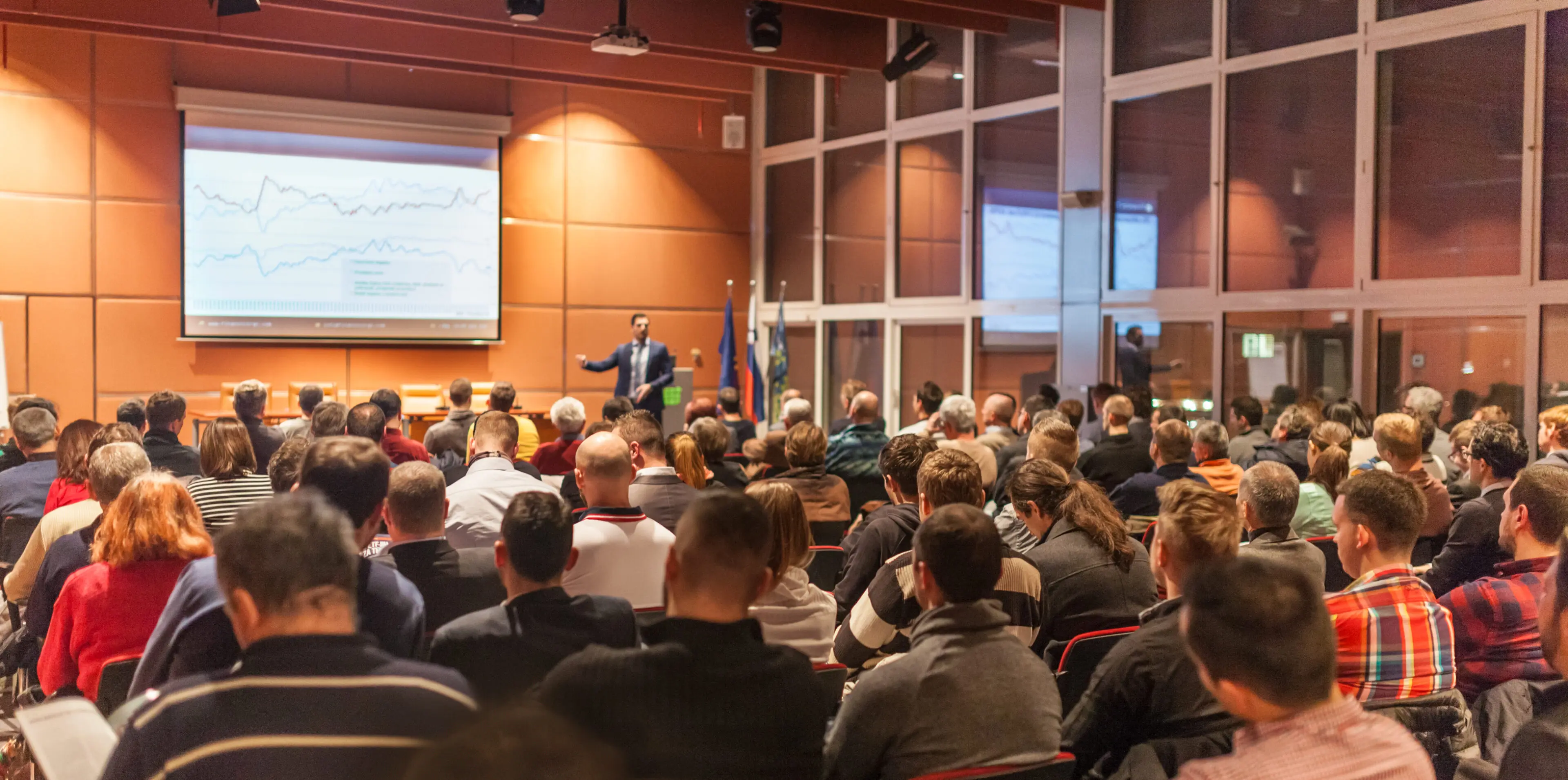 Audience attending a presentation in large conference.
