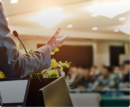 Speaker addressing an audience at podium.