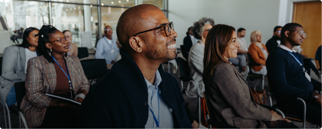 Audience attentively listening at a conference.